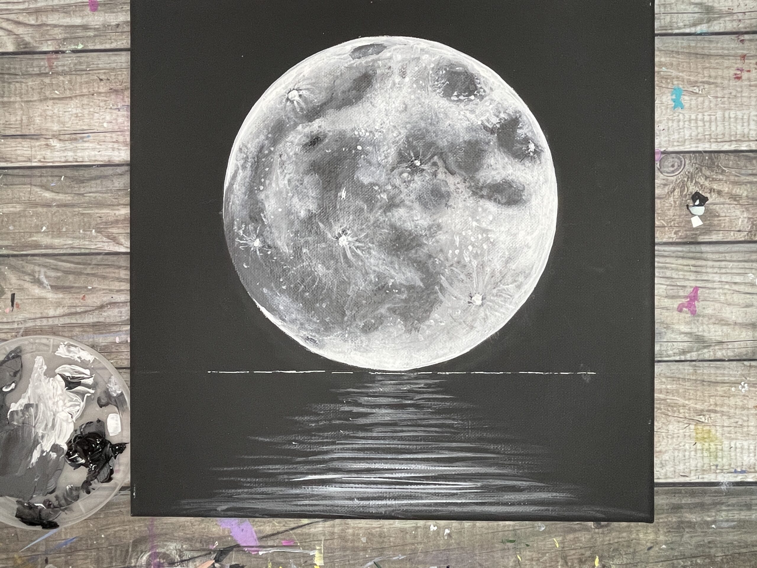 black canvas painting moon reflection