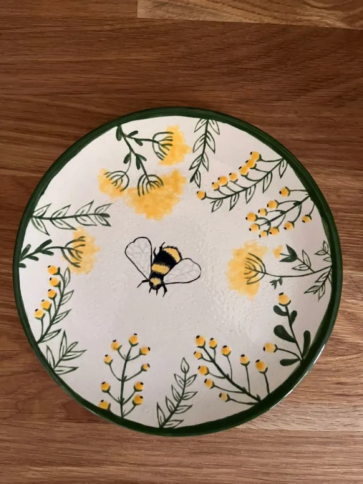 https://feelingnifty.com/wp-content/uploads/2023/07/pottery-painting-idea-bumble-bee-plate.jpg.webp